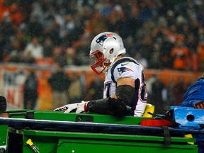In this Nov. 29, 2015, file photo, New England Patriots tight end Rob Gronkowski is carted off the field after being injured against the Denver Broncos during the second half of an NFL football game in Denver. (AP Photo/Jack Dempsey, File)