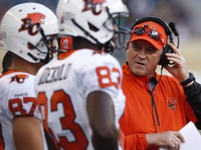 B.C. Lions head coach Jeff Tedford talks to players on the bench during the first half of CFL action against Winnipeg Blue Bombers in Winnipeg July 30, 2015. THE CANADIAN PRESS/John Woods