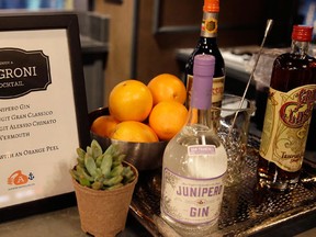 In this photo taken Tuesday, Nov. 17, 2015, a Negroni cocktail station is set up at a holiday party in San Francisco. The beverage stations, once created, mean that guests can help themselves, they don’t have to mix drinks, there isn’t the problem of running out of mixers and guests having to concoct odd beverages with what’s left. The host doesn’t need to lift a finger and is able to enjoy themselves at the party. (AP Photo/Eric Risberg)