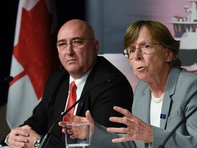 Transportation Safety Board Investigator-in-charge Rob Johnston (left) looks on as TSB Chair Kathy Fox speaks to the media in Ottawa on Wednesday, Dec. 2, 2015 after releasing the final report on the 2013 collision between an OC Transpo bus and a Via Rail train. THE CANADIAN PRESS/Justin Tang