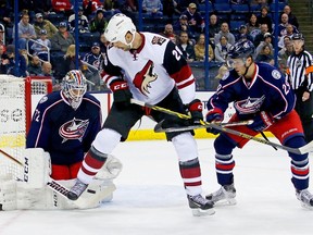 John Scott #28 of the Arizona Coyotes attempts to set a screen in front of Sergei Bobrovsky #72 of the Columbus Blue Jackets while being defended by Cody Goloubef #29 of the Columbus Blue Jackets during the first period on November 14, 2015 at Nationwide Arena in Columbus, Ohio.   Kirk Irwin/Getty Images/AFP