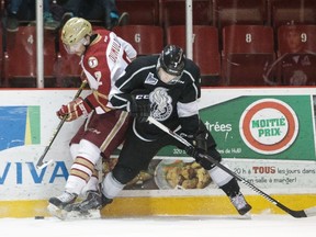 Nicolas Dumulong (2) of the Acadie-Bathurst Titan controls the puck along the boards against Alex Breton of the Gatineau Olympiques on November 25, 2015 at Robert Guertin Arena in Gatineau. (Francois Laplante/FreestylePhoto/Getty Images/AFP)