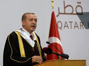 Turkish President Recep Tayyip Erdogan addressing an audience at the university during a ceremony to award him an honourary doctorate in the Qatari capital Doha on December 2, 2015. In comments broadcast by Turkish television, Erdogan denied Russia's claims about Turkey's involvement in illegal oil trading with Islamic State (IS) group jihadists.  (AFP/QATAR UNIVERSITY)