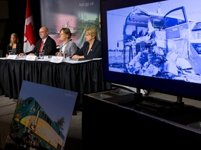 A video presentation showing findings from the 2013 collision between an OC Transpo bus and a Via Rail train is shown during a press conference, as Transportation Safety Board Investigator-in-charge Rob Johnston, TSB Chair Kathy Fox and Board Member Helene Gosselin speak to media after releasing the final report in Ottawa on Wednesday December 2, 2015. 
Errol McGihon/Ottawa Sun