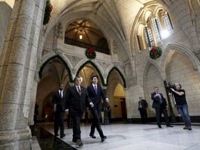 Canada's Prime Minister Justin Trudeau arrives at a Liberal caucus meeting with Member of Parliament Mauril Belanger on Parliament Hill in Ottawa, Canada December 2, 2015. (REUTERS/Chris Wattie)