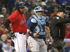 Umpire Dan Bellino goes out to warn David Price of the Tampa Bay Rays after he hit David Ortiz of the Boston Red Sox, left, as catcher Jose Molina of the Rays looks on at Fenway Park on May 30, 2014 in Boston. (Winslow Townson/Getty Images/AFP