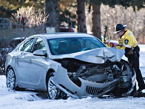 Police are on scene after a car collided with a tree on 71 Avenue and 84 Street in Edmonton, Alta., on Wednesday, Dec. 2, 2015. Injuries were unknown as of 3pm Wednesday. Codie McLachlan/Edmonton Sun