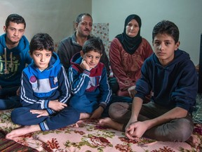 Syrian refugee Abedalhakim Ali Mahmoud from Bosr Alharir, Syria and his wife Nawar are seen with their sons Yousef, 16, Mostafah, 8, twin brother Abdullah, 8, and Salah, 13, left to right, Tuesday, December 1, 2015 in Irbid, Jordan. While this family is waiting for approval to immigrate to Canada, a federal immigration official says many Syrian refugees whom the UN tried to contact don't seem to be interested in coming to Canada. THE CANADIAN PRESS/Paul Chiasson