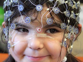 Kaia Anderson-Fillier, 4, wears a cap that measures brain activity while she plays games designed to measure her cognitive abilities as researchers study the relationship between the amount of screen time a child has and their brain development at the University of Alberta on Dec. 2, 2015. CLAIRE THEOBALD Edmonton Sun