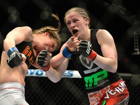 Sarah Kaufman (red gloves) fights Leslie Smith (blue gloves) during their women’s bantamweight bout at Colisee Pepsi in Quebec City. (Eric Bolte/USA TODAY Sports)