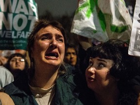 Anti-war protesters react after learning the outcome of the British government's vote on military action against the Islamic State (IS) group in Syria, during a protest outside the Houses of Parliament in central London on December 2, 2015. Britain's parliament voted in favour of joining international air strikes on Islamic State (IS) group targets in Syria. The move proposed by Prime Minister David Cameron's government was approved by a clear majority of 174 MPs, with 397 voting in favour and 223 voting against.   AFP PHOTO / CHRIS RATCLIFFE