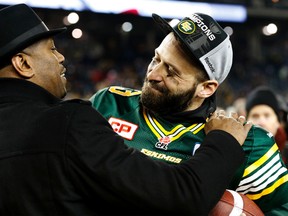 Eskimos GM Ed Hervey, shown here with QB Mike Reilly, took to the field to celebrate the Grey Cup win in Winnipeg on Sunday. (Al Charest, Postmedia Network)