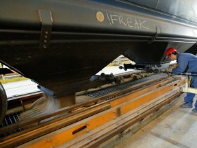 A elevator worker empties a train car at the Port of Churchill.