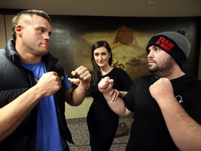Fight promoter Mel Lubovac stands between Adam Braidwood, left, and Paul Mackenzie at the pre-fight presser Wednesday at the Chateau Lacombe in advance of Friday's card at the Shaw Conference Centre. (Perry Mah, Edmonton Sun)