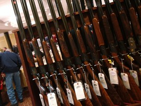A row of shotguns are seen during the East Coast Fine Arms Show in Stamford, Connecticut, in this January 5, 2013 file photo. New data released by the FBI this week shows more Americans applied to purchase firearms from licenced dealers this Black Friday than on any other day on record. REUTERS/Carlo Allegri/Files
