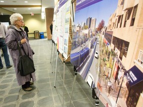 Sandra Colbert, who uses public transit and lives in the east end of London, looks at posters showing details of the proposed $880 million rapid transit system during a public information session at the London Public Library Wednesday. (CRAIG GLOVER, The London Free Press)