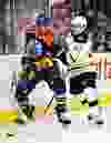 Edmonton's Jujhar Khaira (54) is hit by Boston's Torey Krug (47) during the first period of the Edmonton Oilers' NHL hockey game against the Boston Bruins at Rexall Place in Edmonton, Alta., on Wednesday, Dec. 2, 2015. Codie McLachlan/Edmonton Sun/Postmedia Network