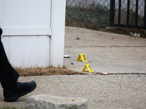Police investigate the scene where a 4-year-old that was mauled by four dogs, Wednesday, Dec. 2, 2015, in Detroit. (Ryan Garza/Detroit Free Press via AP)