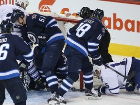 Toronto Maple Leafs' Nick Spaling, right, gets his stick on the puck for the goal against the Winnipeg Jets during third period NHL action in Winnipeg on Wednesday, December 2, 2015. The Jets challenged the goal and it was overturned for goaltender interference. THE CANADIAN PRESS/John Woods