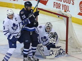 Maple Leafs goaltender Garret Sparks makes a glove save as defenceman Dion Phaneuf battles Jets forward Blake Wheeler during NHL action in Winnipeg on Wednesday, Dec. 2, 2015. (Kevin King/Postmedia Network)