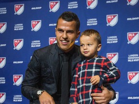 Toronto FC's Sebastian Giovinco - joined by his son, two-year-old Jacopo Giovinco - was presented with the 2015 Landon Donovan MLS MVP award during a ceremony at the Air Canada Centre on Dec. 2, 2015. (ERNEST DOROSZUK/Toronto Sun)