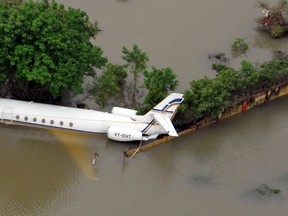 An aerial view of a partially submerged airplane is pictured in a flood affected area in Chennai, India, December 3, 2015. REUTERS/India's Press Information Bureau/Handout via Reuters