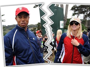 US team member Tiger Woods and his wife Elin Nordegren (R) wait for the rest of the team to finish play after Woods sunk his putt on the 13th green to win his match and clinch the cup win for the US in the Presidents Cup golf competition on October 11, 2009 at Harding Park Golf course in San Francisco.         AFP PHOTO/ROBYN BECK