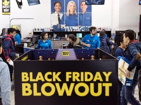 Customers wait in line to purchase electronics at a Best Buy store during Black Friday sales in Toronto on Friday, Nov. 27, 2015. THE CANADIAN PRESS/Darren Calabrese