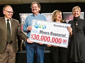 Bill Robinson, AGLC president and CEO, left, and Susan Green, chair of the AGLC board, right, pose with Lotto Max winner Mauro Bagnariol, second from left, and his wife, Helena, second from right, at the Alberta Gaming and Liquor Commission in St. Albert, Alta., on Thursday, Dec. 3, 2015. Bagnariol won $30 million. Codie McLachlan/Edmonton Sun/Postmedia Network