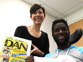 Kathy Alexander, with the Bluewater Health Foundation, and Dan Edwards hold items from the Do It For Dan campaign that raised money for Edwards nearly a decade ago, after a freak accident left him paralyzed from the neck down. Edwards is trying to raise $150,000 for the mental health department at Bluewater Health in a pay-it-forward Do It For Sarnia campaign. (Tyler Kula, The Observer)