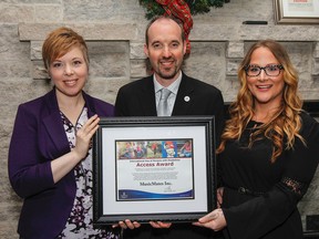 Music Mates Inc. director, Shera Lumsden poses for a photo with Mayor Bryan Paterson, and Music Mates program manager Joann Mendler, after being announced as the 2015 International Day of Persons with Disabilities Access Award at a ceremony held at the Invista Centre in Kingston, Ont. on Thursday December 3, 2015. Julia McKay/The Kingston Whig-Standard/Postmedia Network
