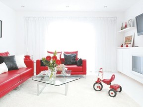 To help balance the scene, red furnishings and white walls are punctuated with black detailing.