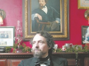 Actor John Huston assumes the same pose as the painting of Charles Dickens at Gad?s Hill Place in Merrickville, named after the country home of Dickens in Higham, Kent. Huston performs his reading of A Christmas Carol Sunday at Aeolian Hall. (PAT McGRATH, Postmedia Network)