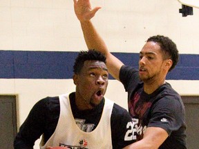 Tyshawn Patterson drives under pressure from Ryan Sypkens during the opening day of London Lightning training camp at the Central Y on Thursday. (DEREK RUTTAN, The London Free Press)