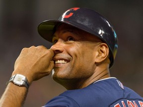 Coach Sandy Alomar of the Cleveland Indians laughs at fans during a game against the Arizona Diamondbacks at Progressive Field August 13, 2014 in Cleveland, Ohio. (Jason Miller/Getty Images/AFP)