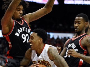 Raptors’ Lucas Nogueira (left) defends Atlanta Hawks guard Jeff Teague during Wednesday’s game in Atlanta. (USA TODAY SPORTS/PHOTO)