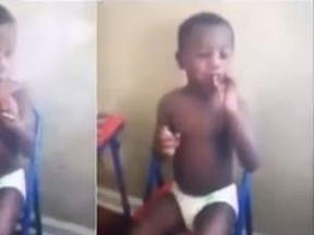 A toddler appears to smoke marijuana while a man gives him direction. (YouTube/Screengrab)