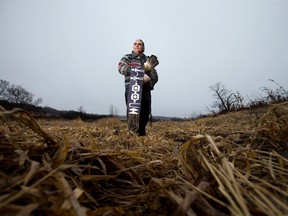 Chippewas of the Thames First Nation band member Myeengun Henry stands on the bank of the Thames River near Plover Mills Drive, where energy company Enbridge's Line 9 runs, northeast of London. The National Energy Board recently approved a reversal of the flow, which would see 300,000 barrels of oil a day from Alberta's oil sands pass through the region on its way to refineries in Montreal. The Chippewas of the Thames are among those speaking out against the pipeline, which is expected to be moving oil sometime this month.  (CRAIG GLOVER, The London Free Press)