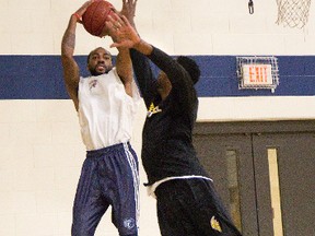 Jeremy Wise shoots over Warren Ward during the opening day of London Lightning training camp at the Central Y on Thursday. (DEREK RUTTAN, The London Free Press)
