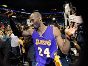 Kobe Bryant of the Los Angeles Lakers leaves the court after the game against the Minnesota Timberwolves on December 14, 2014 at Target Center in Minneapolis after passing Michael Jordan on the all-time scoring list. (Hannah Foslien/Getty Images/AFP)