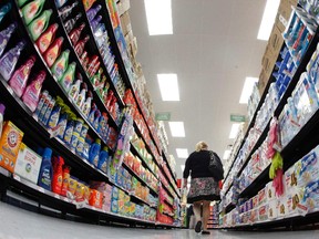 A shopper walks down an aisle in a newly opened Walmart Neighborhood Market in Chicago September 21, 2011. (REUTERS/Jim Young/Files)