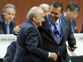 FIFA President Sepp Blatter listens to Juan Angel Napout, President of the South American Football Confederation (CONMEBOL) during the 65th FIFA Congress in Zurich, Switzerland in this May 29, 2015 file photo. (REUTERS/Arnd Wiegmann)
