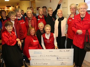 BRUCE BELL/The Intelligencer
Prince Edward County Memorial Hospital Auxiliary members are pictured at the hospital's donor wall Thursday, making a donation for $150,000 to the PECMH Foundation LIFE SAVER Campaign. The donation pushed the auxiliary over the $1 million mark, making it the first member at the Humanitarian level.