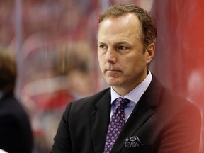 Tampa Bay Lightning head coach Jon Cooper looks on from behind the bench against the Washington Capitals in the third period at Verizon Center. The Capitals won 4-2. Mandatory Credit: Geoff Burke-USA TODAY Sports
