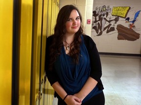 Lynnelle Cantwell poses inside Holy Trinity High School in Torbay, N.L., on Dec. 3, 2015. A young woman from Newfoundland and Labrador is getting flowers, support and thousands of positive messages for turning a case of online bullying into what her mother calls "something beautiful." Lynelle Cantwell, a grade 12 student at Holy Trinity High School outside St. John's, was named in a poll posted on the website ask.fm called 'Ugliest Girls in Grade 12.' (THE CANADIAN PRESS/Paul Daly)