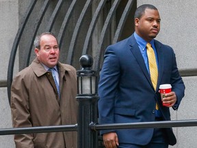 Baltimore Police officer William Porter (R) approaches the court House in Baltimore, Maryland, in this file photo from November 30, 2015. Porter is one of six Baltimore City police officer charged in connection with the death of Freddie Gray from a spinal injury while in custody. Porter failed to secure him in the back of a van and ignored his request for medical aid, a prosecutor said in opening statements December 2, 2015. (REUTERS/Rob Carr/Pool/Files)