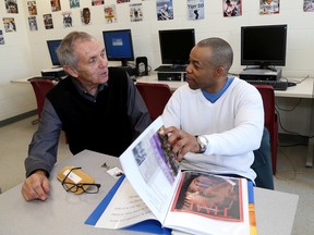 Teacher Lee McNaughton, left, and inmate Michael Reid at the prison school in Collins Bay Institution in Kingston. (Ian MacAlpine /The Whig-Standard)