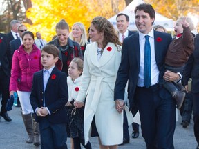 Marilou Trayvilla, one of two women employed to take care of the Trudeau children, is seen at left as she joins prime minister-designate Justin Trudeau and family upon their arrival to Rideau Hall for the swearing-in ceremony in Ottawa on Wednesday, November 4, 2015. A spokesperson for Justin Trudeau is defending the prime minister's use of taxpayer dollars to finance two nannies who are helping to look after the family's three children. THE CANADIAN PRESS/Sean Kilpatrick