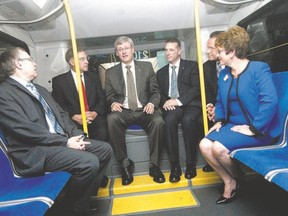 Former prime minister Stephen Harper, centre, rides a bus in Kitchener Sept. 2, after announcing his government will provide up to $265 million to support the construction of a rapid transit project for the Kitchener-Waterloo-Cambridge region. (CRAIG GLOVER, Free Press file photo)
