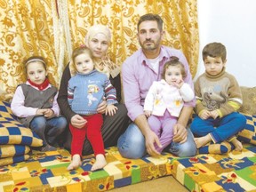 Refugee Samer Albqerat from Tal Shehab, Syria, sits with his wife, Doaa, and daughters Nada, 6, Braa, 3, Goly, nine months, and son, Khald, 5, in Irbid, Jordan. The family is waiting for approval to immigrate to Canada. Columnist Glen Pearson says most refugees have been waiting in countries such as Lebanon, Egypt, Turkey, Iraq and Jordan for more than five years. (Paul Chiasson, The Canadian Press)